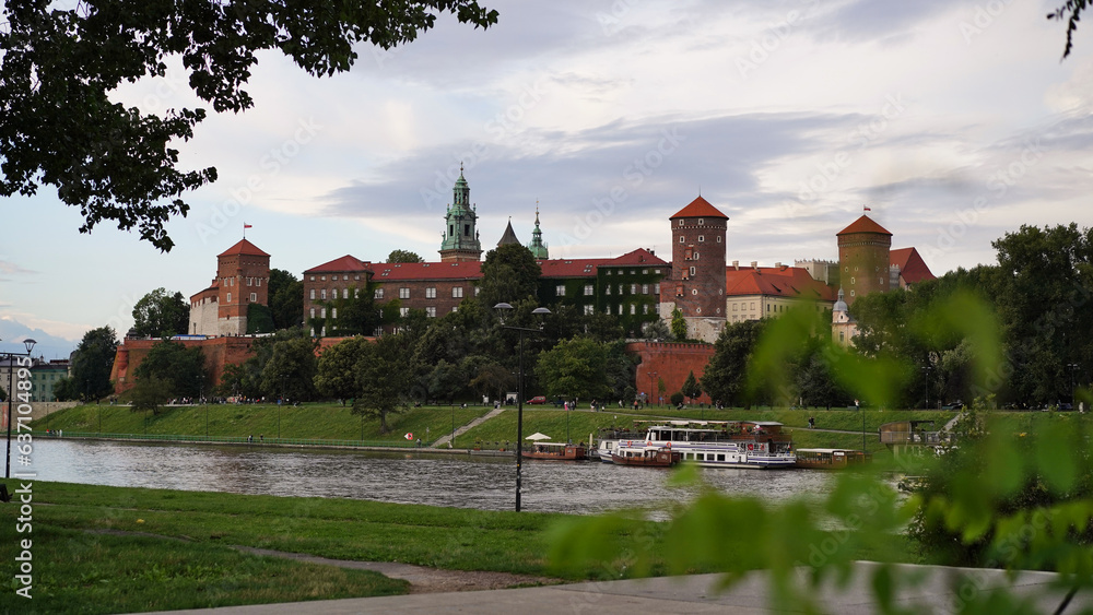 Beautiful old royal Wawel Castle on the banks of Vistula river in the evening. The main historical landmark of Krakow, a popular tourist destination in Poland.Old town, place for vacation and travel.