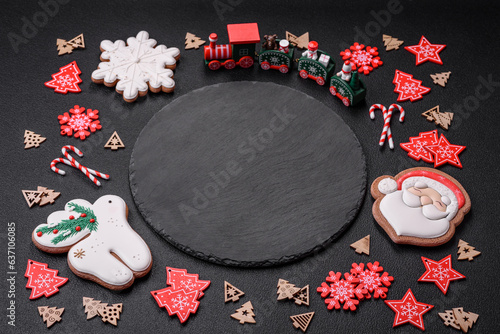 Empty dark ceramic plate with elements of Christmas decorations