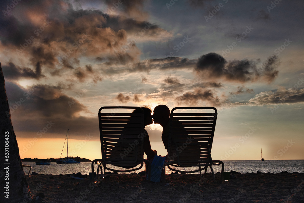 Couple kissing on the beach at sunset Couple kissing on the beach at sunset