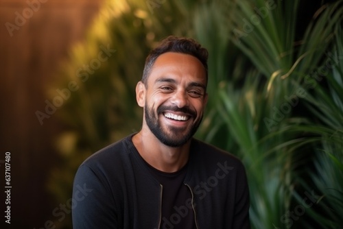 Portrait of a handsome Indian man smiling and looking at the camera