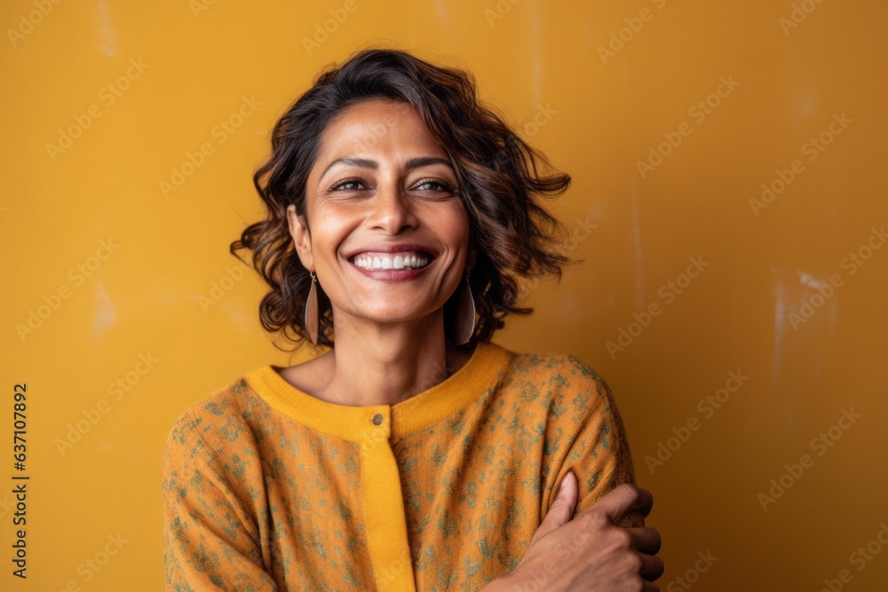 Group portrait of an Indian woman in her 40s in an abstract background