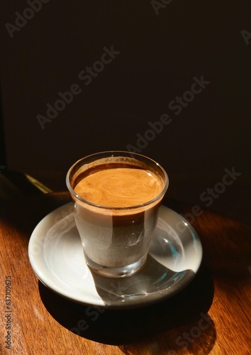 Pour the milk into a glass with cold brewed coffee on a black background