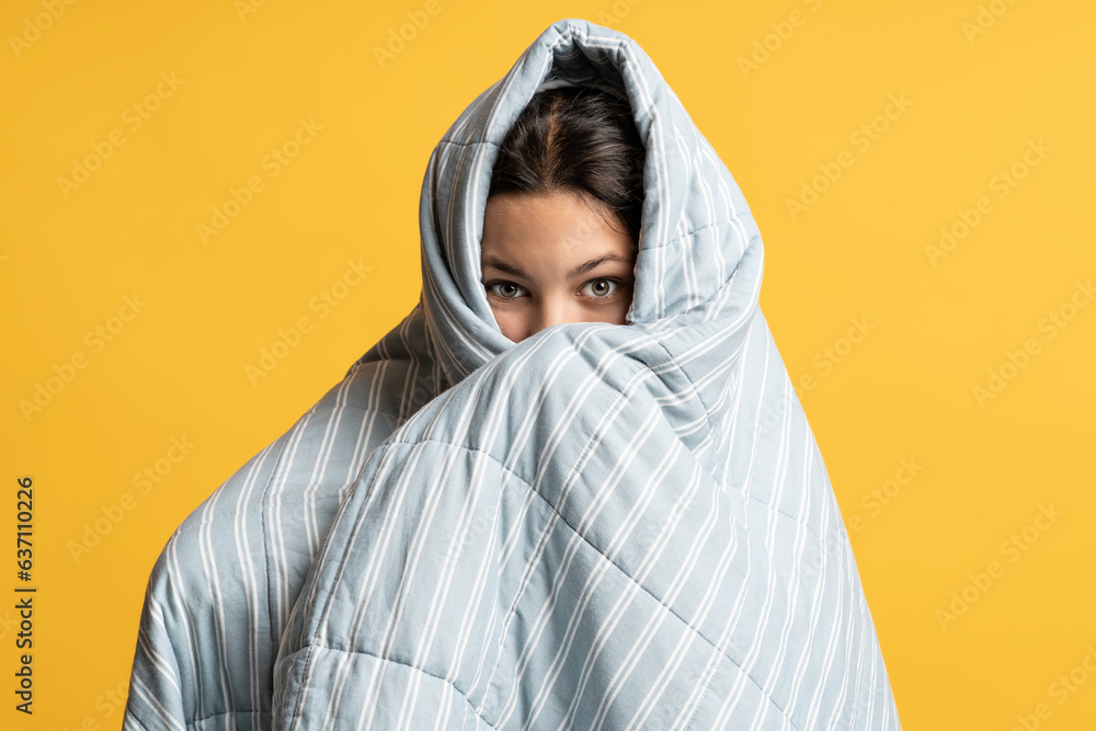 © DimaBerlin - Teenage girl hid in gray blanket. Frightened brunette teen girl, covered, wrapped with thin, light, soft, comfortable duvet. Concept of sweet sleep, dreams, scary horror stories, histories, daydreams.