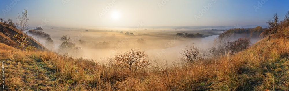 Autumn sunrise landscape, panorama, banner - view of a river valley covered with fog in the light of the sunrays, the northeast of Ukraine