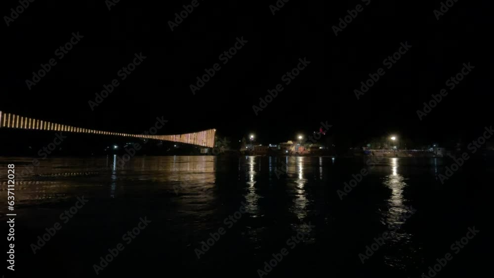 Night view of Ram jhula bridge with lights reflecting on Ganges river Night view of Ram jhula bridge with lights reflecting on Ganges river