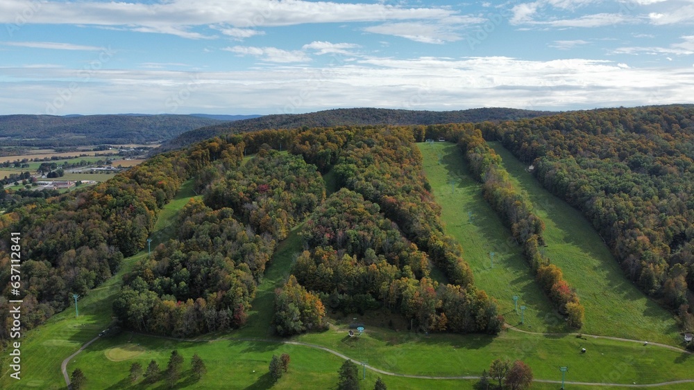 Aerial view of a green mountain range on a sunny day