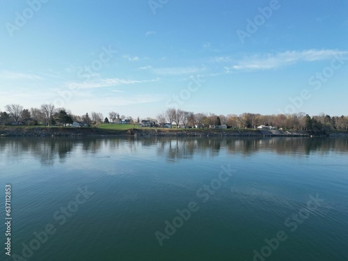 Scenic view of houses on the shore of a tranquil lake on a sunny day