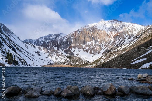 Scenic view of snow-capped Sierra Nevada mountains with Convict Lake in foreground