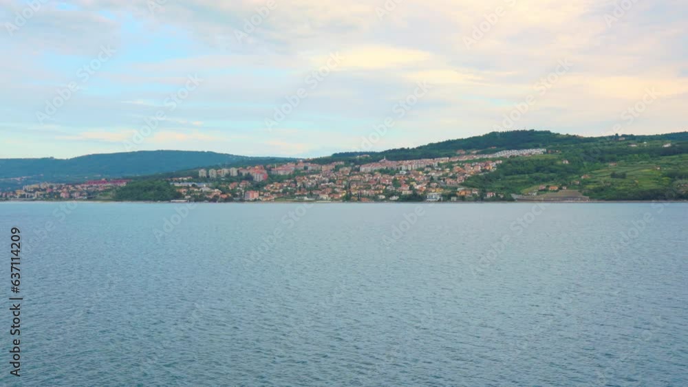 Beautiful view of seascape with a mountain town in the background in Koper, Slovenia Beautiful view of seascape with a mountain town in the background in Koper, Slovenia