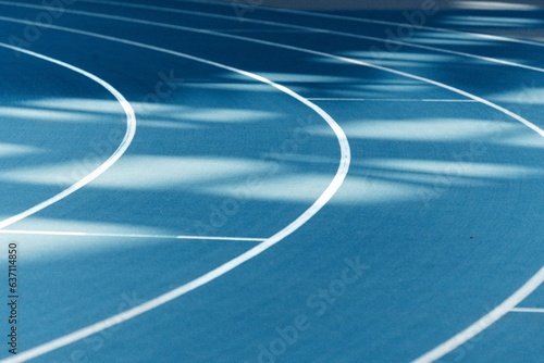 Fotografia Blue running track with crisp white lines.