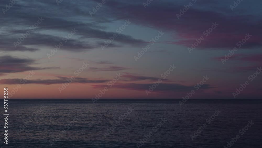 Beautiful sunset with purple clouds and flying birds over the sea Beautiful sunset with purple clouds and flying birds over the sea