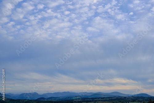 Cloudscape over mountains, daylight scenery