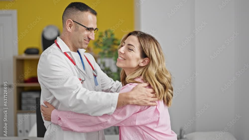 Man and woman doctor and patient hugging each other smiling at the clinic Man and woman doctor and patient hugging each other smiling at the clinic