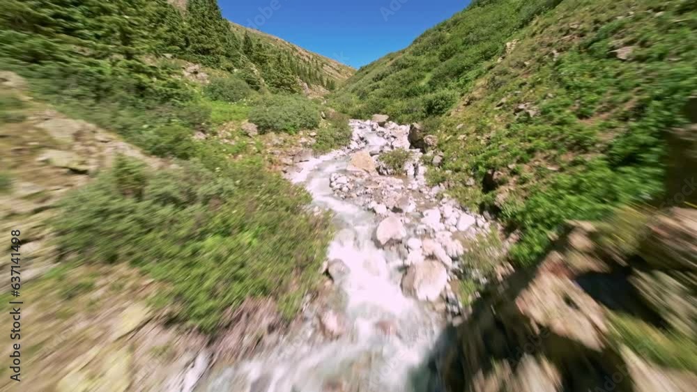 Zooming aerial view (FPV) over alpine stream Zooming aerial view (FPV) over alpine stream