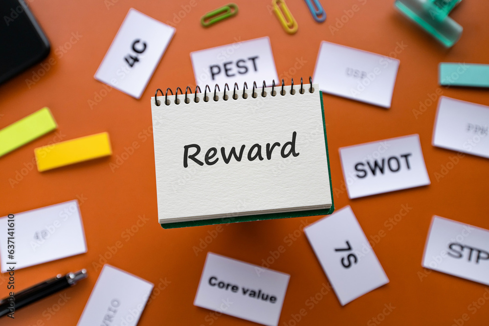 There is wood cube with the word Reward. It is an abbreviation for Reward as eye-catching image. There is wood cube with the word Reward. It is an abbreviation for Reward as eye-catching image.