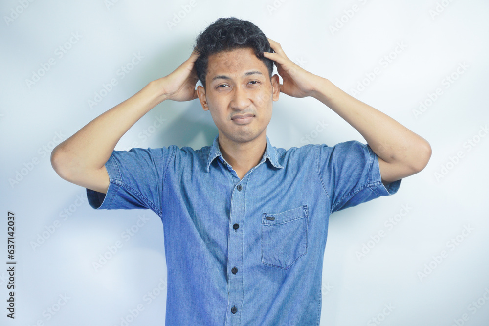 Young handsome man over isolated background suffering from headache desperate and stressed because pain and migraine. Hands on head. Young handsome man over isolated background suffering from headache desperate and stressed because pain and migraine. Hands on head.