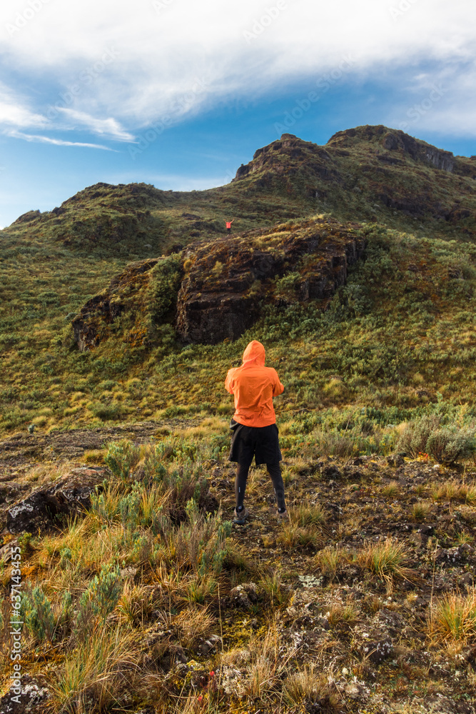 hiker contemplating the mountain in the middle of the paramo in the Chirripo National Park in Costa Rica hiker contemplating the mountain in the middle of the paramo in the Chirripo National Park in Costa Rica
