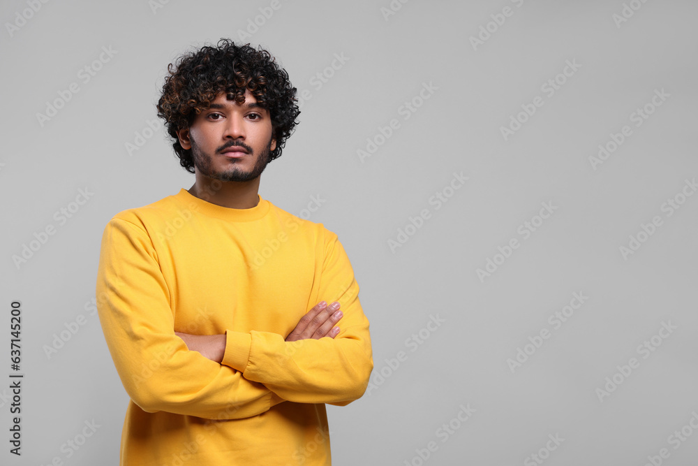 Handsome young man on light grey background, space for text Handsome young man on light grey background, space for text