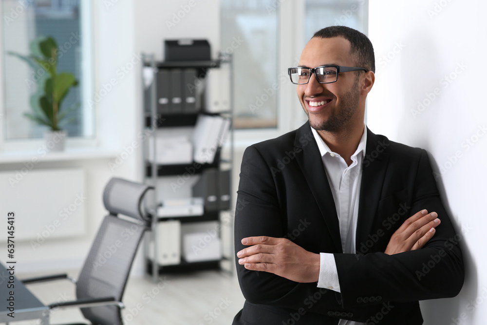 Smiling young businessman in office. Space for text Smiling young businessman in office. Space for text