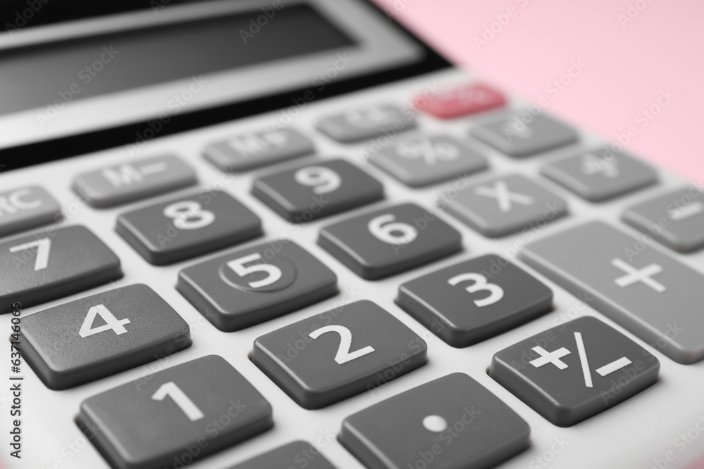 Calculator on pink background, closeup. Office equipment Calculator on pink background, closeup. Office equipment
