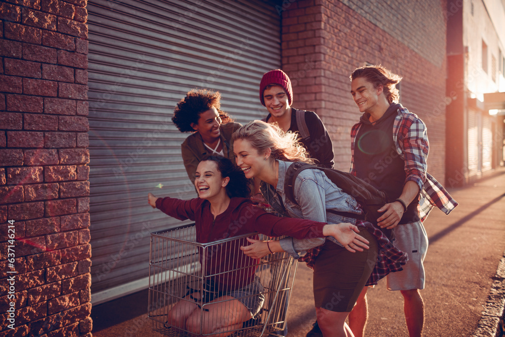 Diverse group of young people walking on a sidewalk and having fun ...