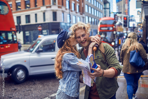 Young caucasian couple exploring london on their vacation photo