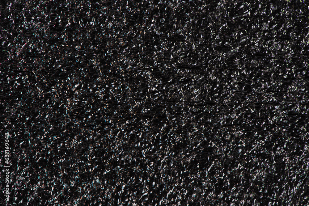 Black soft foam board background. black sponge surface texture. Black soft foam board background. black sponge surface texture.