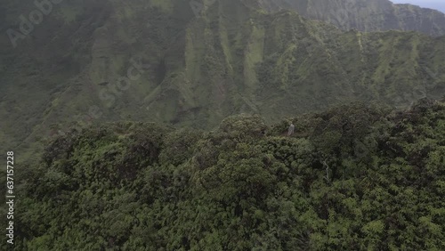 Hikers on thick jungle mountain ridge top trail on Oahu Hawaii, aerial photo