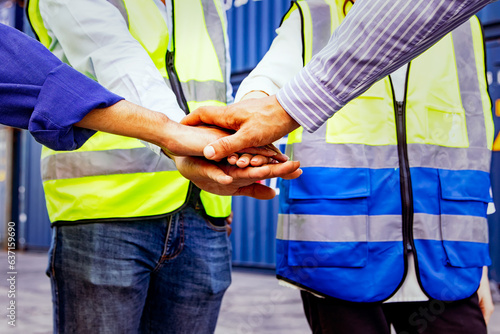 Close up of hands clasped together : Successful teamwork concept : Civil engineering worker group stacked hands high together and coordinating fieldwork in organization. Cooperation, unity, teamwork.