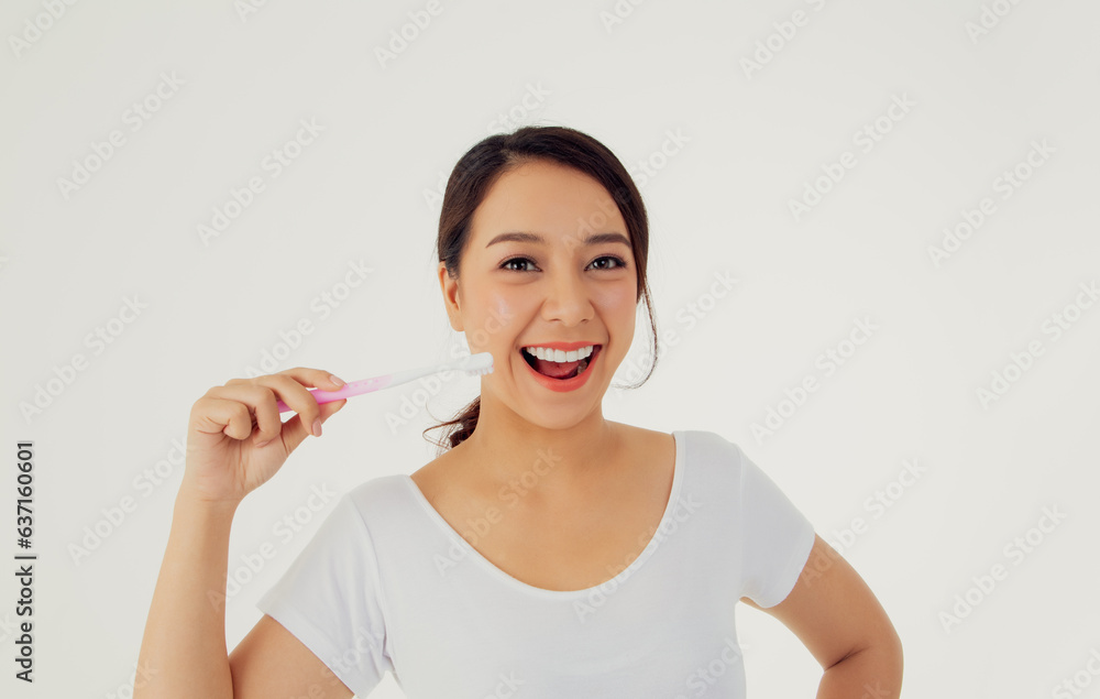 Asian woman beautiful clean teeth : Happy woman taking care of her teeth perfectly shows toothbrush to prevent tooth decay and treat oral cavity : Row of white clean attractive teeth beautiful smile. Asian woman beautiful clean teeth : Happy woman taking care of her teeth perfectly shows toothbrush to prevent tooth decay and treat oral cavity : Row of white clean attractive teeth beautiful smile.