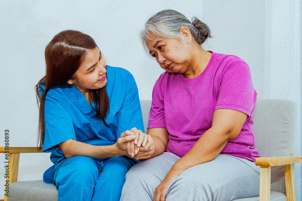 Female doctor takes care elderly patient suffering from depression love holding hands with concern: Mental rehabilitation nurse caring comforting encouraging helping make the mind relaxed and happy. Female doctor takes care elderly patient suffering from depression love holding hands with concern: Mental rehabilitation nurse caring comforting encouraging helping make the mind relaxed and happy.