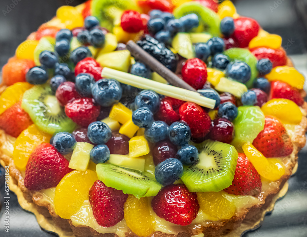 Delicious cake with fresh strawberries, blueberries and kiwi on the table. Top view Delicious cake with fresh strawberries, blueberries and kiwi on the table. Top view