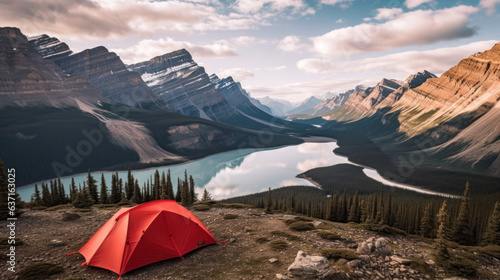 Camping with red tent to the lake and mountains