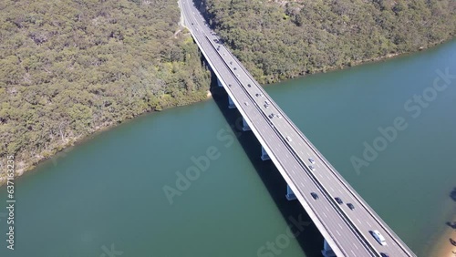 Aerial drone view of Alfords Point Bridge across Georges River between Padstow Heights in the City of Bankstown and Alfords Point in the Sutherland Shire in Sydney, New South Wales, Australia  photo