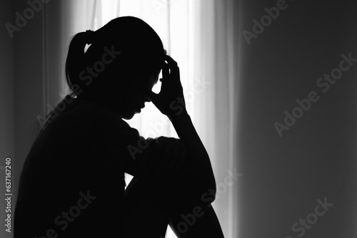 Asian woman sitting on the house area Feeling sad, tired and worried about depression, mental health problems and heartbreaking concept.