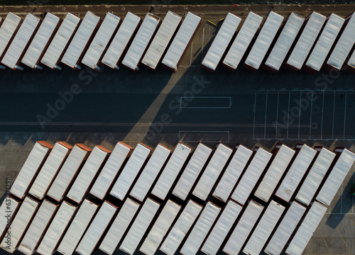 Drone shot of shipping containers at Tilbury docks containing rolls of newsprint (newspaper) paper.