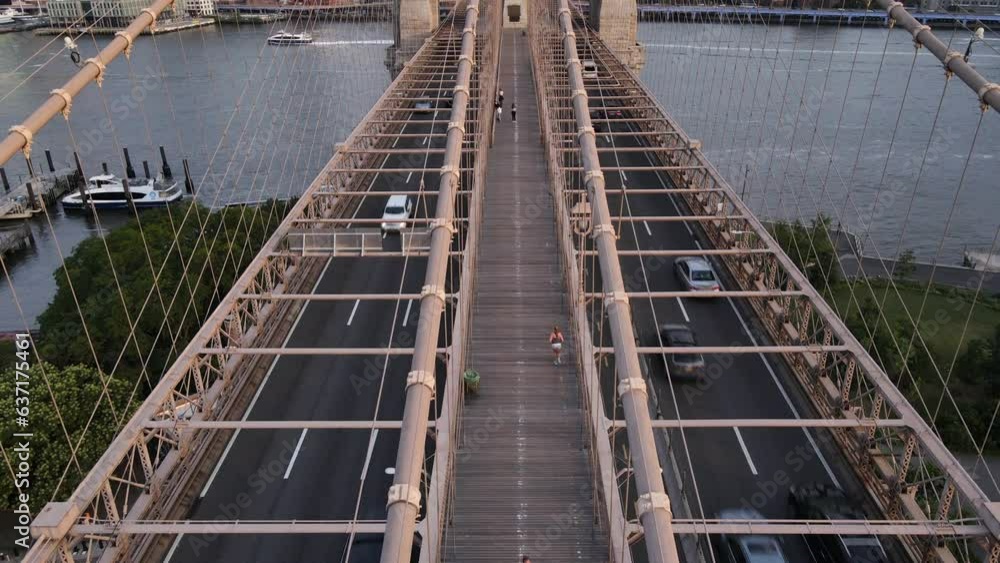 Aerial shot of an unrecognizable person running across The Brooklyn Bridge Aerial shot of an unrecognizable person running across The Brooklyn Bridge