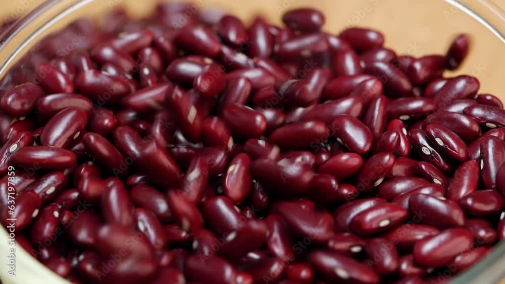 A pile of red beans on a wooden surface, table, and close up A pile of red beans on a wooden surface, table, and close up