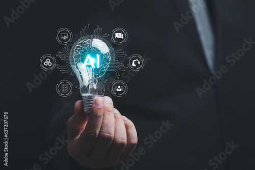 Businessman holding light bulb, brain icon of artificial intelligence, Futuristic business Innovation that connects global networks. Smart Solutions, Chatbots, Technology Business. AI chatbot concept.
