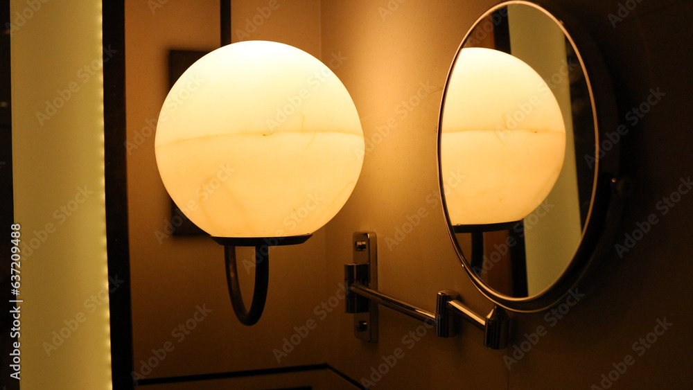 Round elegant wall lamp lights up