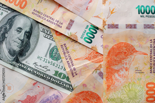 Принти на полотні a 100 dollar bill with many argentine bills of 1000 pesos, concept of inflation