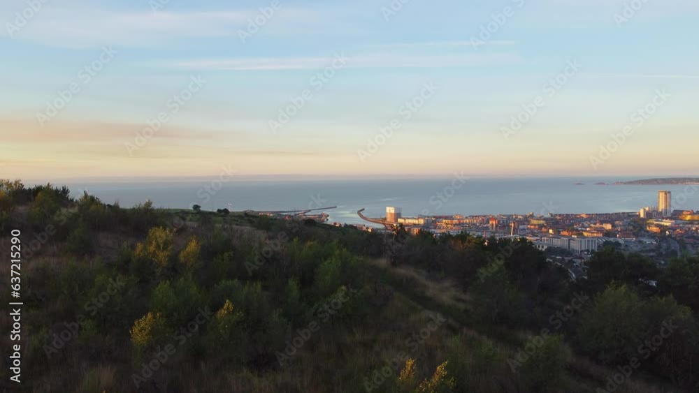 Rising Aerial View of Hills and City at Dawn with Buildings and Marina Rising Aerial View of Hills and City at Dawn with Buildings and Marina