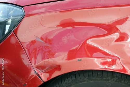 Close up of a damange red car from accident for texture and background.