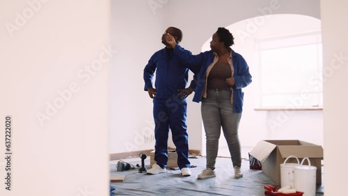 Black Woman Discussing Her DIY Ideas with Her Black Partner photo