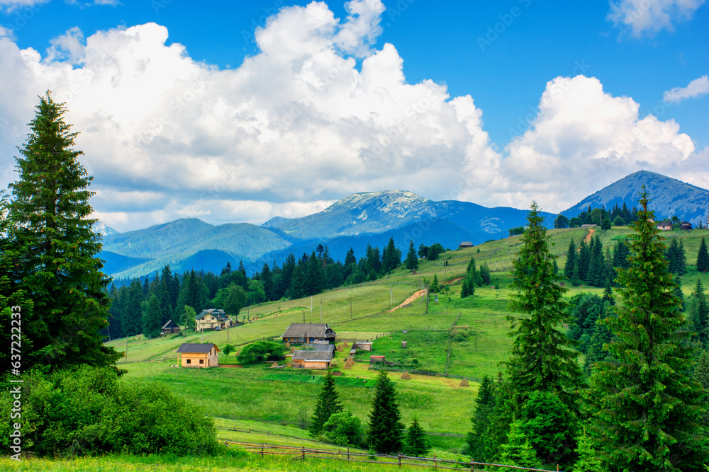 Beautiful scenery of a village in a valley against the backdrop of blue mountains, travel, vacation. High quality photo