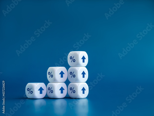 Rise up arrows on white cube blocks bar graph chart steps with percentage icon isolated on blue background with copy space. Investment  income  trends  business growth  economic improvement concepts.