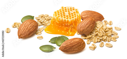 Almond nuts, rolled oats, green pumpkin seeds and honey isolated on white background photo