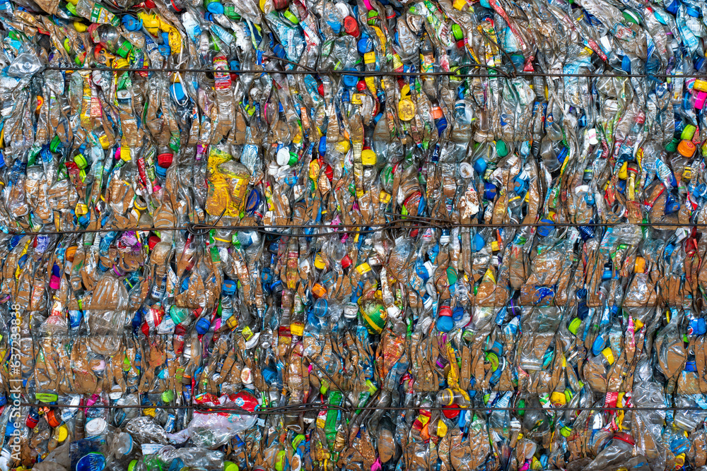 Bundle of plastic bottles and plastic wasted products being smashed and tightly tied up for recycle purpose