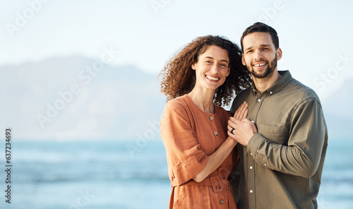 Couple, outdoor and portrait with love, marriage and happy from travel by the ocean. Smile, hug and gratitude from a woman and man together with care on vacation and relax on holiday in summer