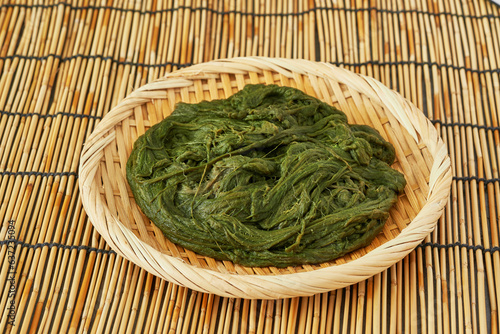 Spirogyra Korean seaweed alga fulvescens or Maesaengi in wood plate on table or bamboo mat background. Spirogyra Korean seaweed alga fulvescens or Maesaengi. seaweed alga fulvescens Spirogyra food photo